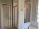 Bathroom with a walk-in shower featuring glass door and convenient hooks for hanging towels at 541 Arena Dr, Davenport, FL 33837