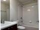 Cozy bathroom features a combination of a bathtub and shower, toilet, and sink with a mirror at 541 Arena Dr, Davenport, FL 33837