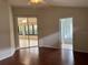 Bedroom features hardwood floors, with access to the bathroom and sunroom at 541 Arena Dr, Davenport, FL 33837
