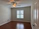 Inviting bedroom features hardwood floors and a window with shutter providing plenty of natural light at 541 Arena Dr, Davenport, FL 33837
