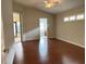 Bedroom with hardwood floors, and access to the bathroom and sunroom at 541 Arena Dr, Davenport, FL 33837