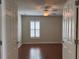 Bright bedroom features hardwood floors and a window with shutter providing plenty of natural light at 541 Arena Dr, Davenport, FL 33837