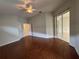 Hardwood floor bedroom featuring bright light, ceiling fan, and adjacent doors at 541 Arena Dr, Davenport, FL 33837