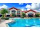 Inviting community pool area with lounge chairs and lush landscaping at 541 Arena Dr, Davenport, FL 33837