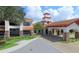 Exterior view showcasing the porte cochere, clock tower, and landscaping at 541 Arena Dr, Davenport, FL 33837