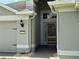 Inviting front entrance with glass storm door, brick paved walk, and neutral painted finishes at 541 Arena Dr, Davenport, FL 33837