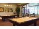 Well-lit game room with two billiard tables, large windows, and comfortable seating at 541 Arena Dr, Davenport, FL 33837