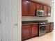 Updated kitchen boasting stainless steel appliances, granite countertops, and dark wood cabinets at 541 Arena Dr, Davenport, FL 33837