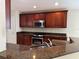 Kitchen island featuring a sink with granite countertops and stainless steel appliances at 541 Arena Dr, Davenport, FL 33837