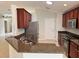 Kitchen featuring stainless appliances, granite countertops, and dark wood cabinets with tiled floors at 541 Arena Dr, Davenport, FL 33837