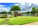 Picturesque lake view with a gazebo on a pier and manicured lawn at 541 Arena Dr, Davenport, FL 33837