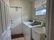 Laundry room with a washer and dryer, utility sink and door to backyard for convenience at 541 Arena Dr, Davenport, FL 33837