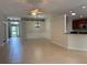 Spacious living area with tile floors offering a view of the front door and adjacent kitchen at 541 Arena Dr, Davenport, FL 33837