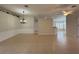 Open living area with ceramic tile flooring, stylish chandelier, and views of multiple rooms at 541 Arena Dr, Davenport, FL 33837