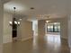 An open living room with neutral paint, tile floors, and open views to the dining and sun room at 541 Arena Dr, Davenport, FL 33837