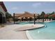Community pool with lounge chairs, umbrellas, and a vibrant atmosphere, perfect for relaxation and recreation at 541 Arena Dr, Davenport, FL 33837