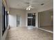 Sunroom featuring tile flooring, white walls, and an exit door to the backyard at 541 Arena Dr, Davenport, FL 33837