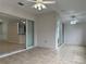 Open-concept sunroom with tiled floors, ceiling fans and sliding glass doors at 541 Arena Dr, Davenport, FL 33837