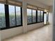 Beautiful sunroom featuring tile flooring, window blinds, and scenic backyard views at 541 Arena Dr, Davenport, FL 33837