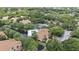Community aerial view showcases well-maintained landscaping, a sparkling pool, tennis court, and cozy residences at 5436 E Michigan St # 7, Orlando, FL 32812