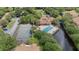 Aerial shot highlighting the community amenities, including the tennis court, pool, and clubhouse nestled amidst nature at 5436 E Michigan St # 7, Orlando, FL 32812
