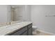 Bathroom vanity with gray cabinets, granite counters, tile floors, and a shower/tub combo at 5436 E Michigan St # 7, Orlando, FL 32812