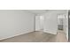 Spacious bedroom with wood-look floors, leading to a walk-in closet and bathroom at 5436 E Michigan St # 7, Orlando, FL 32812