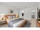 Comfortable bedroom with a cozy bed, stylish decor, and en-suite bathroom access at 5436 E Michigan St # 7, Orlando, FL 32812