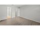 This bedroom features neutral walls, wood-look floors, and an open closet at 5436 E Michigan St # 7, Orlando, FL 32812