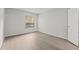 Bright bedroom features neutral walls, wood-look floors, and a window with a view at 5436 E Michigan St # 7, Orlando, FL 32812
