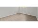 Bright bedroom with neutral walls, wood-look floors, and a window with a view of the outdoors at 5436 E Michigan St # 7, Orlando, FL 32812