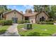 Community clubhouse boasts manicured landscaping, verdant green grass and welcoming entrance perfect for gatherings and events at 5436 E Michigan St # 7, Orlando, FL 32812