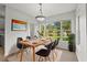 Sunlit dining area with a view of the pond through large windows at 5436 E Michigan St # 7, Orlando, FL 32812