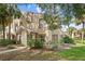 Inviting exterior view of a townhome featuring manicured landscaping and a charming entrance at 5436 E Michigan St # 7, Orlando, FL 32812