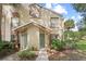 Charming townhome with well-maintained grounds, lush greenery, and a welcoming facade at 5436 E Michigan St # 7, Orlando, FL 32812
