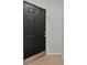 Solid dark-colored front door of the property at 5436 E Michigan St # 7, Orlando, FL 32812
