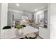 Well-lit kitchen featuring light countertops, modern cabinets, and a breakfast bar at 5436 E Michigan St # 7, Orlando, FL 32812