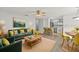 Open-concept living area featuring modern furniture, a ceiling fan, and seamless access to the kitchen at 5436 E Michigan St # 7, Orlando, FL 32812