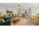 Open-concept living area features a modern kitchen, cozy seating, and inviting dining space at 5436 E Michigan St # 7, Orlando, FL 32812