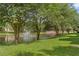 Scenic view of a pond with a fountain, surrounded by lush green trees and well-maintained grassy areas at 5436 E Michigan St # 7, Orlando, FL 32812