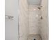 Bathroom shower showcasing marble-look tiles and modern fixtures at 5436 E Michigan St # 7, Orlando, FL 32812