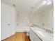 Clean bathroom featuring a tub, tile walls, granite counters and wooden flooring at 5500 Metrowest Blvd # 203, Orlando, FL 32811