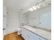 Well-lit bathroom with granite countertop, white cabinets, and a shower-tub combo at 5500 Metrowest Blvd # 203, Orlando, FL 32811