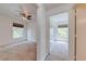 Bright bedroom with neutral carpet, ceiling fan, window, and closet at 5500 Metrowest Blvd # 203, Orlando, FL 32811