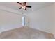 Bright carpeted bedroom showing a ceiling fan and window at 5500 Metrowest Blvd # 203, Orlando, FL 32811