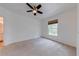 Neutral bedroom with a ceiling fan and window at 5500 Metrowest Blvd # 203, Orlando, FL 32811