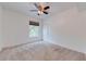 Bright carpeted bedroom featuring a ceiling fan, window, and closet at 5500 Metrowest Blvd # 203, Orlando, FL 32811