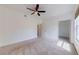 Bright carpeted bedroom with ceiling fan and window at 5500 Metrowest Blvd # 203, Orlando, FL 32811