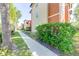 Exterior view of a walking path next to well-maintained landscaping and the condo building at 5500 Metrowest Blvd # 203, Orlando, FL 32811