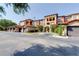 Beautiful exterior view of a multi-story condo building with red tile roofs and attached garages at 5500 Metrowest Blvd # 203, Orlando, FL 32811